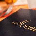 Menu & Cutlery on A Restaurant Table